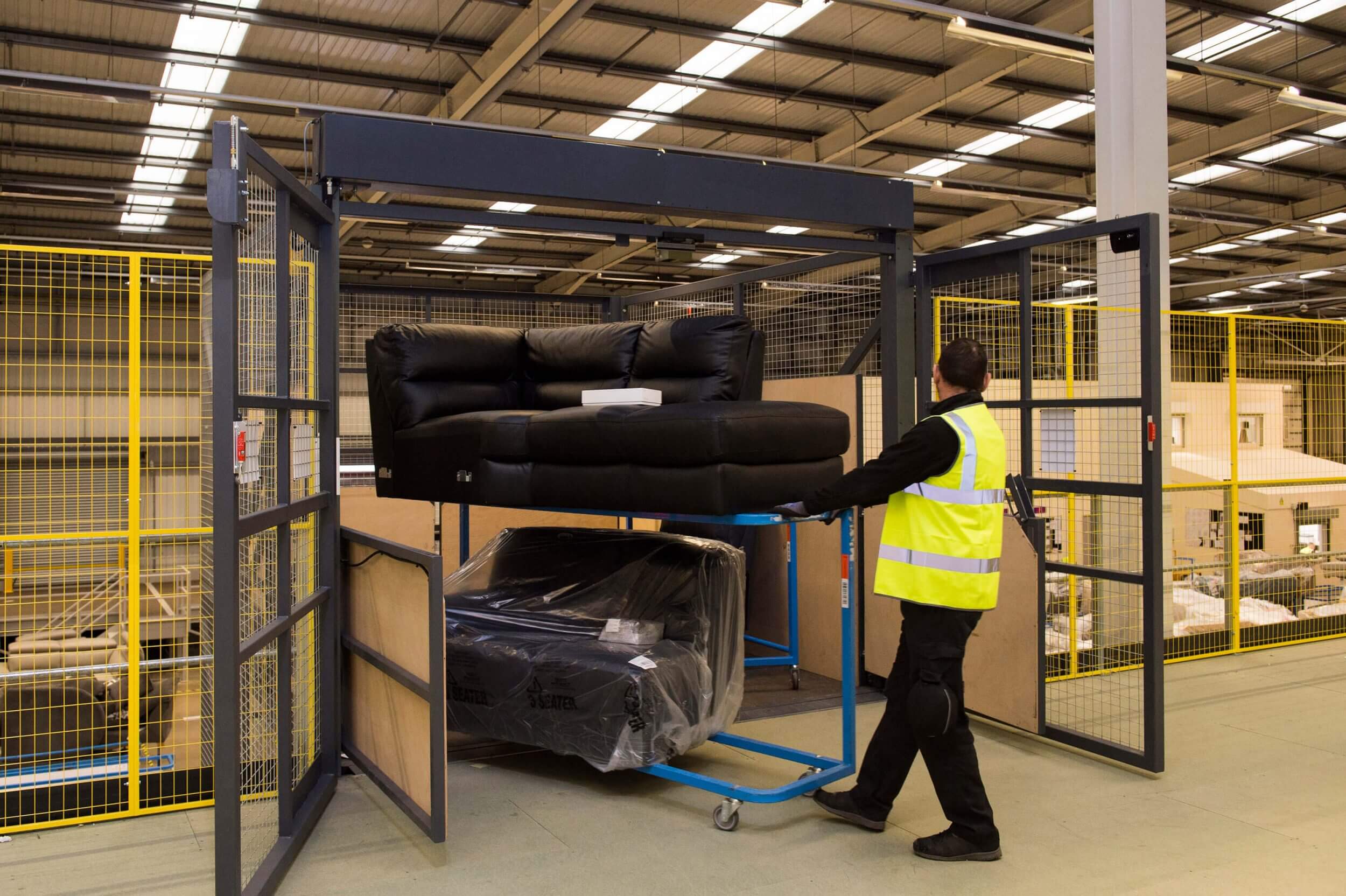 Man removing sofas from goods lift